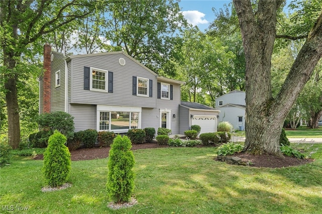 2331 Woodpark Rd, Fairlawn, OH 44333 - colonial-style house featuring a chimney, an attached garage, and a front yard