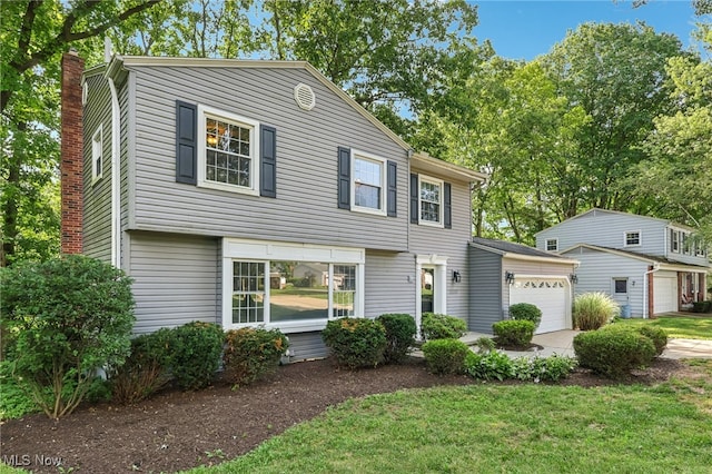 2331 Woodpark Rd, Fairlawn, OH 44333 - colonial-style house with a garage, concrete driveway, a chimney, and a front yard