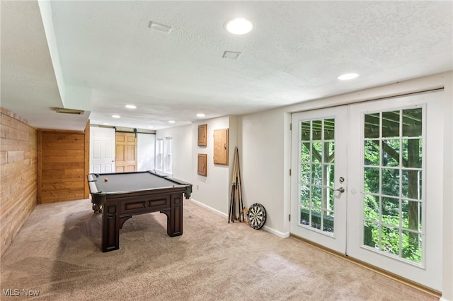 2331 Woodpark Rd, Fairlawn, OH 44333 - game room with a barn door, a textured ceiling, light colored carpet, recessed lighting, and wooden walls