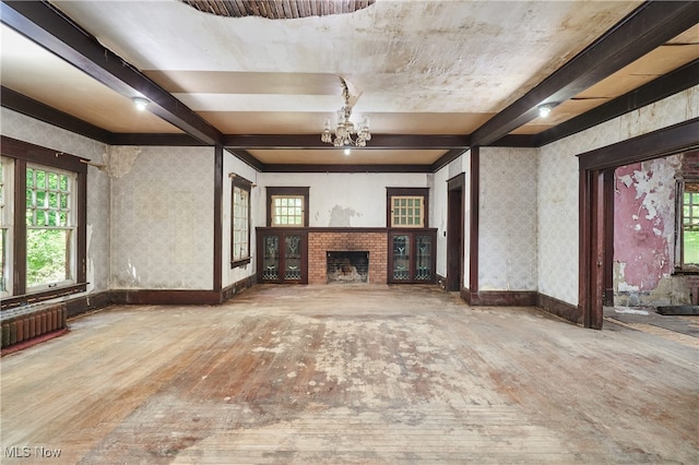 74 Maplewood Ave, Akron, OH 44313 - unfurnished living room with a chandelier, radiator, beamed ceiling, wallpapered walls, and a fireplace