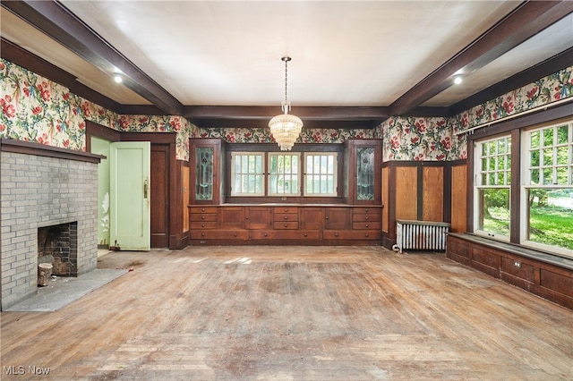 74 Maplewood Ave, Akron, OH 44313 - unfurnished living room with wallpapered walls, a wainscoted wall, a chandelier, radiator, and beam ceiling