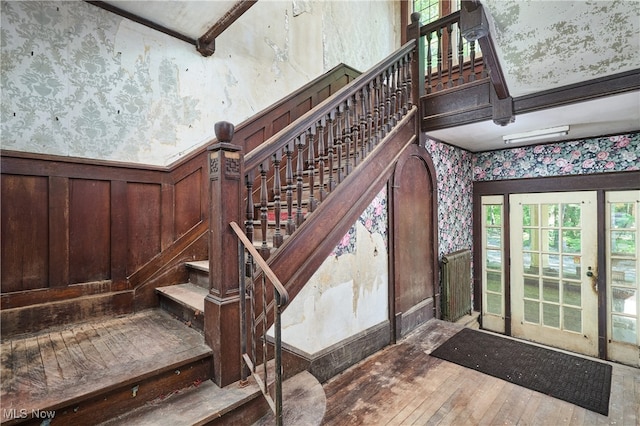 74 Maplewood Ave, Akron, OH 44313 - stairs with wallpapered walls, hardwood / wood-style floors, and a wainscoted wall