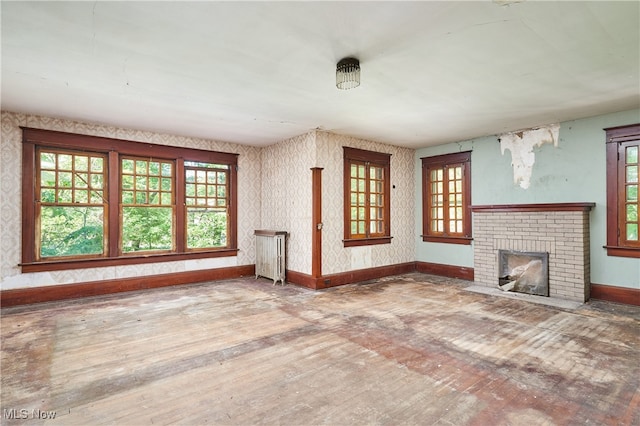74 Maplewood Ave, Akron, OH 44313 - unfurnished living room featuring hardwood / wood-style flooring, healthy amount of natural light, and a fireplace