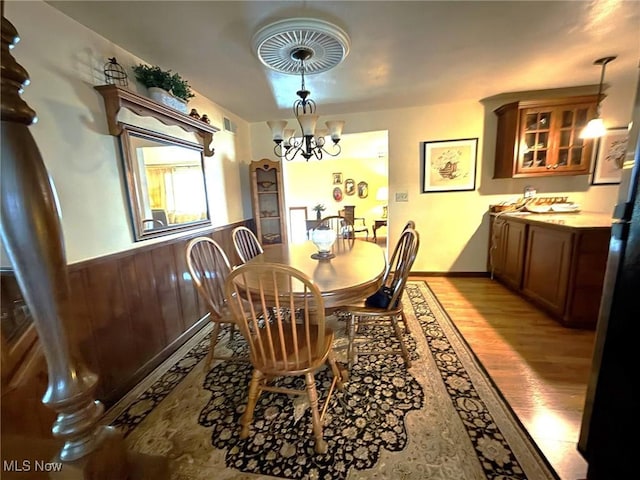 120 Kennedy Ave, Follansbee, WV 26037 - dining room with light wood finished floors, a chandelier, wainscoting, and wood walls