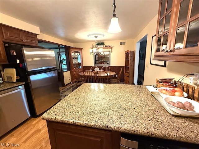 120 Kennedy Ave, Follansbee, WV 26037 - kitchen with appliances with stainless steel finishes, light stone countertops, light wood-style flooring, a chandelier, and pendant lighting