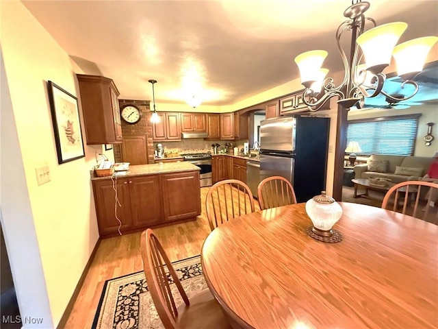 120 Kennedy Ave, Follansbee, WV 26037 - dining area with light wood-style floors, a chandelier, and arched walkways