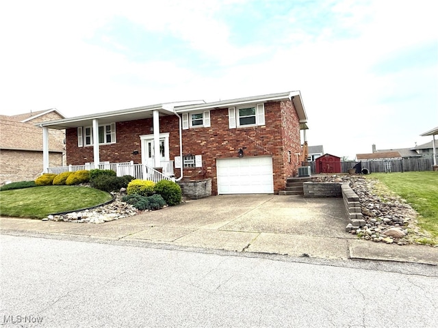 120 Kennedy Ave, Follansbee, WV 26037 - raised ranch with an attached garage, brick siding, driveway, and covered porch