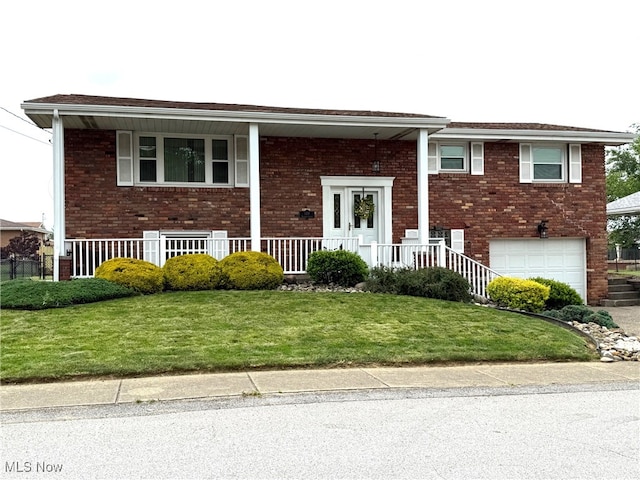 120 Kennedy Ave, Follansbee, WV 26037 - raised ranch featuring brick siding, covered porch, and an attached garage