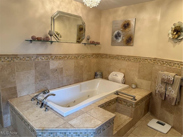 9237 Shephard Rd, Macedonia, OH 44056 - bathroom featuring a tub with jets, a chandelier, and a wainscoted wall