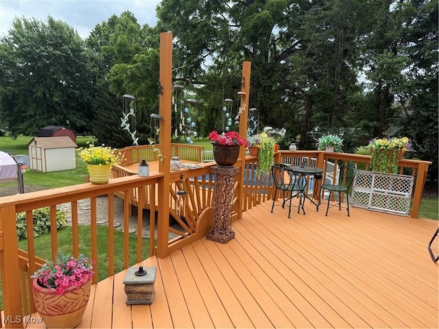 9237 Shephard Rd, Macedonia, OH 44056 - deck featuring outdoor dining area, a shed, a lawn, and view of wooded area