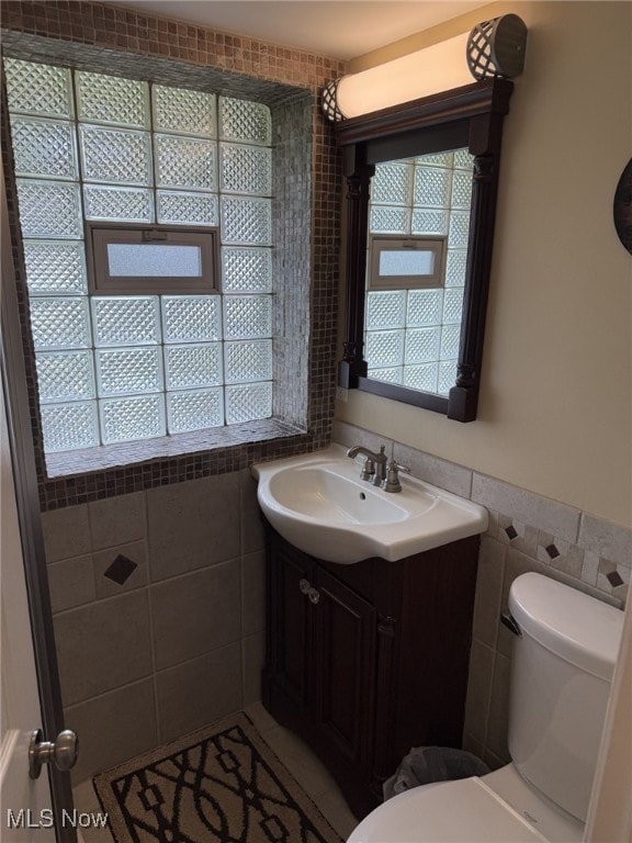 9237 Shephard Rd, Macedonia, OH 44056 - half bath with tile walls, vanity, and a wainscoted wall