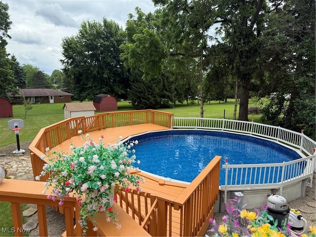 9237 Shephard Rd, Macedonia, OH 44056 - swimming pool with a shed, a yard, a wooden deck, and view of scattered trees