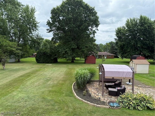 9237 Shephard Rd, Macedonia, OH 44056 - view of green lawn with a storage shed, a patio area, and view of wooded area