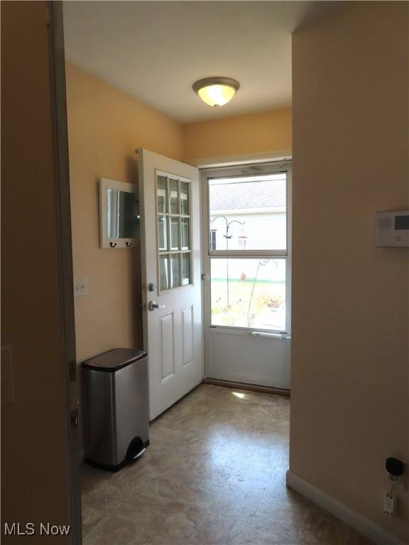 723 Whisper Creek Ln, Lodi, OH 44254 - doorway with tile patterned floors and baseboards