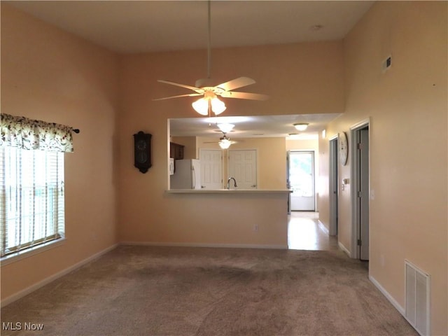 723 Whisper Creek Ln, Lodi, OH 44254 - unfurnished living room with light colored carpet and a ceiling fan