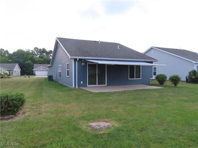 723 Whisper Creek Ln, Lodi, OH 44254 - back of property featuring a patio area, a lawn, and a shingled roof