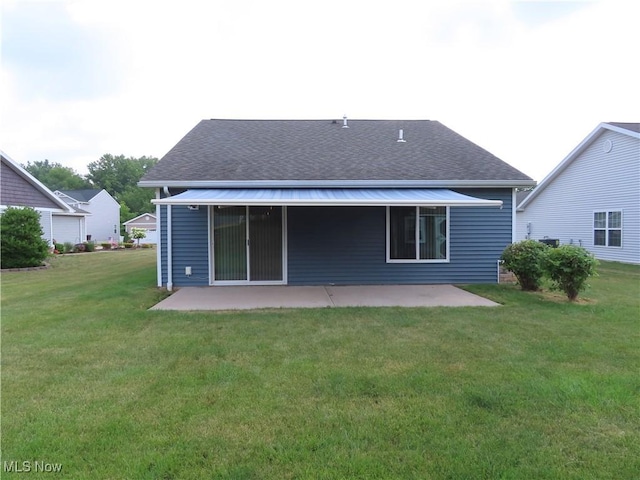 723 Whisper Creek Ln, Lodi, OH 44254 - rear view of house featuring a patio area, roof with shingles, and a lawn