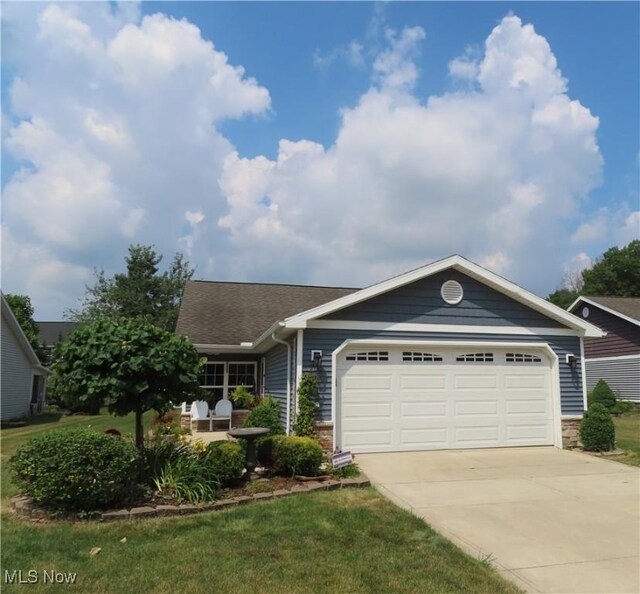 723 Whisper Creek Ln, Lodi, OH 44254 - single story home with concrete driveway, a garage, roof with shingles, and stone siding