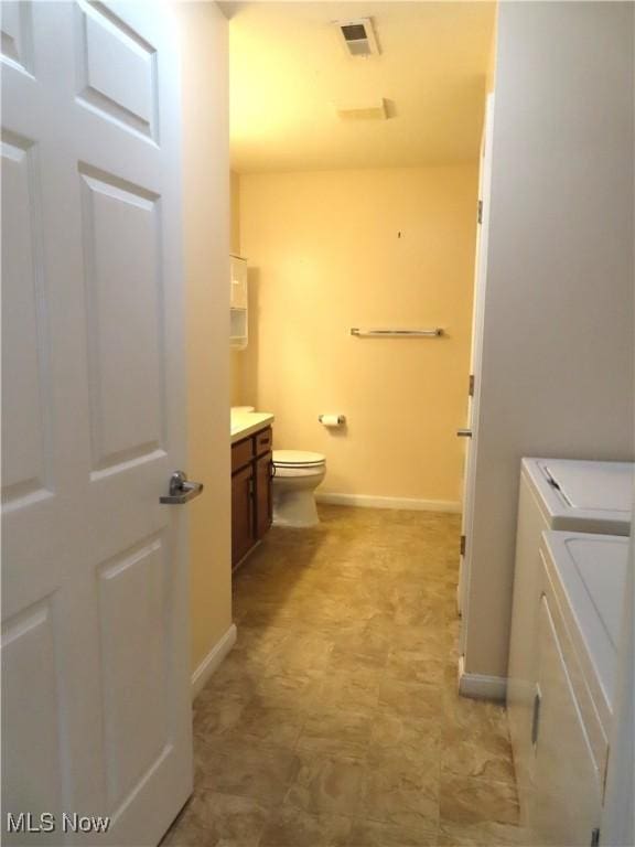 723 Whisper Creek Ln, Lodi, OH 44254 - bathroom featuring separate washer and dryer, tile patterned floors, and vanity