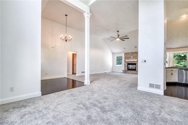 9798 Firestone Ln, Macedonia, OH 44056 - unfurnished living room featuring dark carpet, a ceiling fan, a fireplace, high vaulted ceiling, and a chandelier
