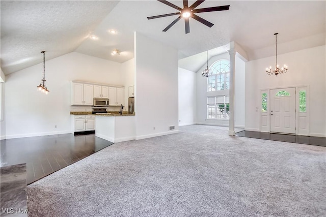 9798 Firestone Ln, Macedonia, OH 44056 - unfurnished living room featuring a chandelier, high vaulted ceiling, dark colored carpet, and ceiling fan