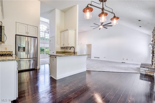 9798 Firestone Ln, Macedonia, OH 44056 - kitchen featuring appliances with stainless steel finishes, high vaulted ceiling, stone countertops, dark wood-style flooring, and a ceiling fan