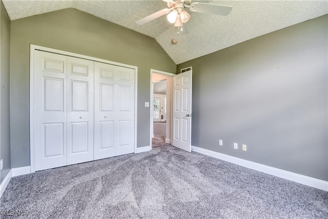9798 Firestone Ln, Macedonia, OH 44056 - unfurnished bedroom with lofted ceiling, carpet floors, a closet, a textured ceiling, and ceiling fan