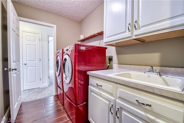 9798 Firestone Ln, Macedonia, OH 44056 - washroom with cabinet space, independent washer and dryer, dark wood-type flooring, a textured ceiling, and dark carpet