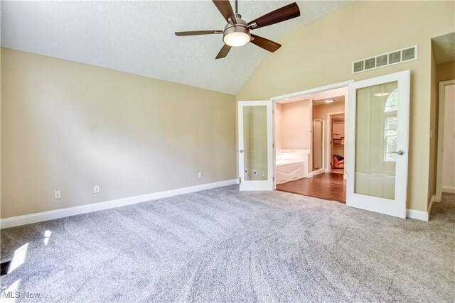 9798 Firestone Ln, Macedonia, OH 44056 - unfurnished bedroom featuring french doors, dark carpet, high vaulted ceiling, and ceiling fan
