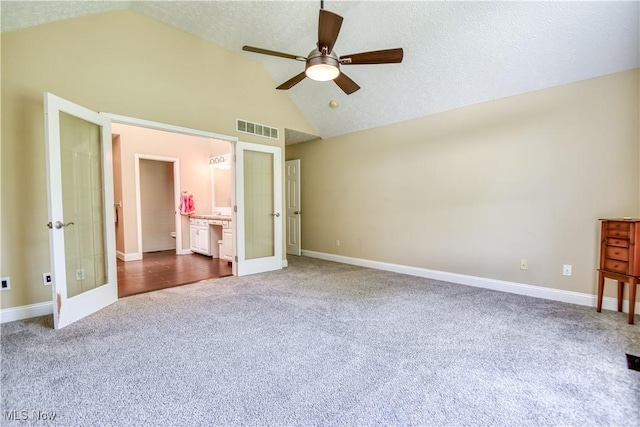 9798 Firestone Ln, Macedonia, OH 44056 - unfurnished bedroom with french doors, dark carpet, high vaulted ceiling, ensuite bathroom, and ceiling fan
