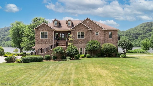 390 Powell Riverfront Rd, Saint Marys, WV 26170 - view of front of home with a front yard, brick siding, and stairway