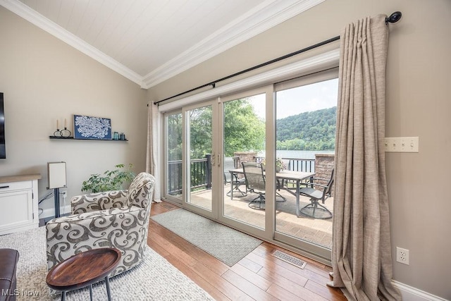 390 Powell Riverfront Rd, Saint Marys, WV 26170 - living area featuring ornamental molding, wood finished floors, vaulted ceiling, a water view, and a forest view