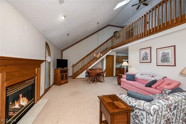 1412 Tewksbury Cir Unit 1C, Cuyahoga Falls, OH 44221 - living area featuring a ceiling fan, carpet flooring, high vaulted ceiling, a fireplace with flush hearth, and a textured ceiling
