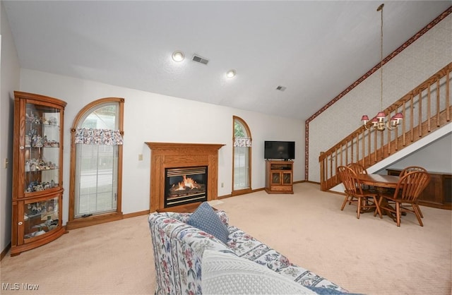 1412 Tewksbury Cir Unit 1C, Cuyahoga Falls, OH 44221 - carpeted living room with stairs, lofted ceiling, and a glass covered fireplace