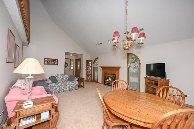 1412 Tewksbury Cir Unit 1C, Cuyahoga Falls, OH 44221 - carpeted dining area with a chandelier, a glass covered fireplace, and high vaulted ceiling