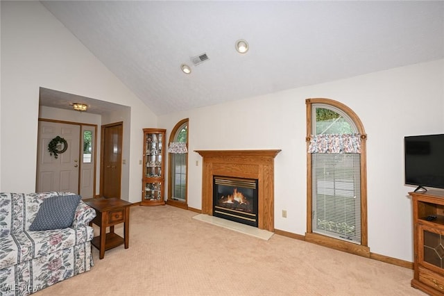1412 Tewksbury Cir Unit 1C, Cuyahoga Falls, OH 44221 - living room featuring healthy amount of natural light, light colored carpet, a glass covered fireplace, vaulted ceiling, and recessed lighting