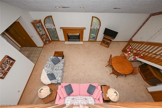 1412 Tewksbury Cir Unit 1C, Cuyahoga Falls, OH 44221 - carpeted living room featuring a textured ceiling and a glass covered fireplace