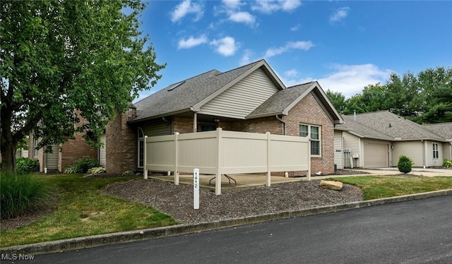 1412 Tewksbury Cir Unit 1C, Cuyahoga Falls, OH 44221 - view of front facade with brick siding, an attached garage, and a shingled roof