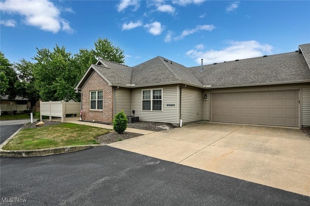 1412 Tewksbury Cir Unit 1C, Cuyahoga Falls, OH 44221 - view of front of home with concrete driveway, a shingled roof, an attached garage, and brick siding