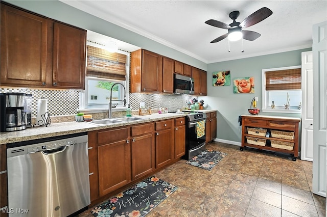 2107 13th St, Cuyahoga Falls, OH 44223 - kitchen featuring stainless steel appliances, tasteful backsplash, a ceiling fan, light countertops, and ornamental molding