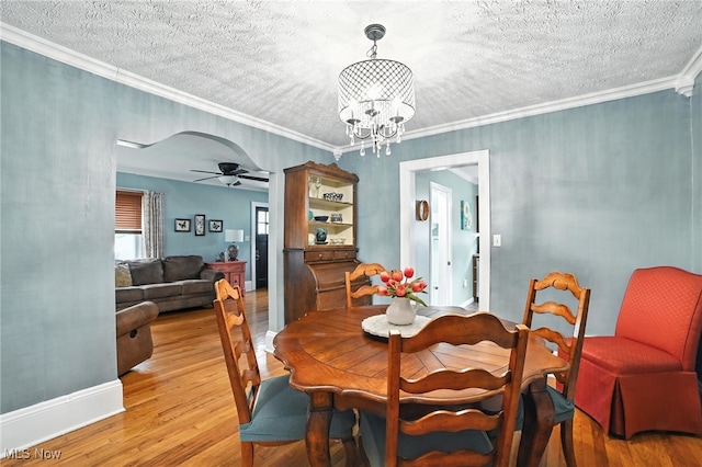 2107 13th St, Cuyahoga Falls, OH 44223 - dining room featuring a ceiling fan, light wood-style flooring, a chandelier, a textured ceiling, and crown molding