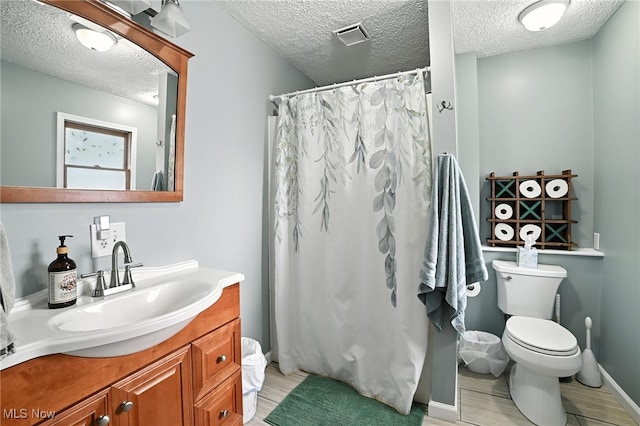 2107 13th St, Cuyahoga Falls, OH 44223 - bathroom featuring a textured ceiling, vanity, a shower with shower curtain, and wood finished floors