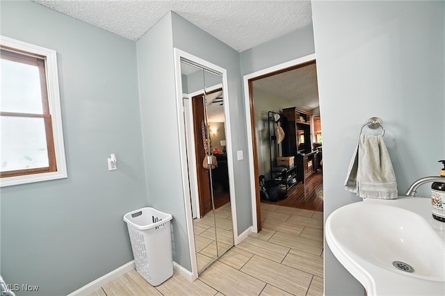 2107 13th St, Cuyahoga Falls, OH 44223 - bathroom featuring a textured ceiling and wood finish floors