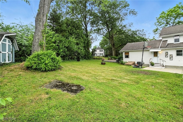 2107 13th St, Cuyahoga Falls, OH 44223 - view of green lawn with entry steps, a patio, and a shed