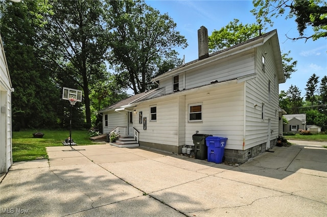 2107 13th St, Cuyahoga Falls, OH 44223 - back of property with a chimney, a patio, and a lawn