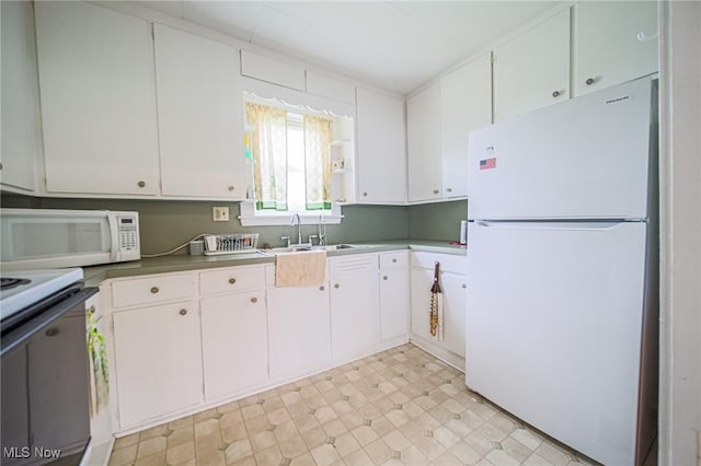 6248 Massillon Rd SW, Navarre, OH 44662 - kitchen featuring white appliances, white cabinetry, and light floors