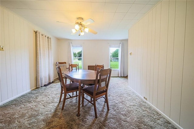 6248 Massillon Rd SW, Navarre, OH 44662 - dining room with carpet, a ceiling fan, and wooden walls