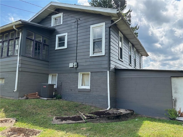 748 Belleview Rd, Cambridge, OH 43725 - view of property exterior with a cooling unit and a lawn