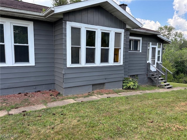 748 Belleview Rd, Cambridge, OH 43725 - view of side of home with entry steps, a yard, and a chimney