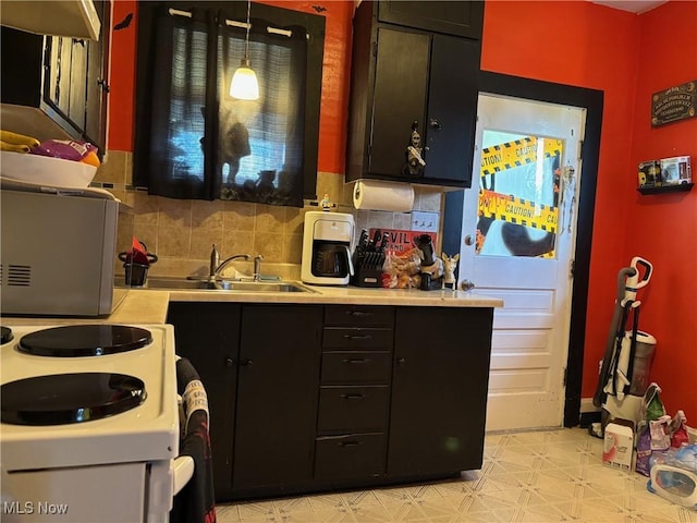 748 Belleview Rd, Cambridge, OH 43725 - kitchen featuring light countertops, dark cabinets, light flooring, and decorative backsplash